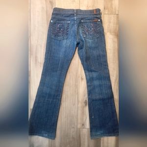 Boot cut jeans with blingy skull on back pockets